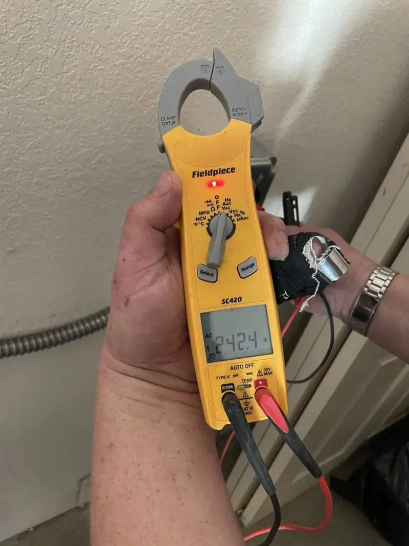 Voltage testing with clamp meter during Whole House Surge Protector in Roscoe